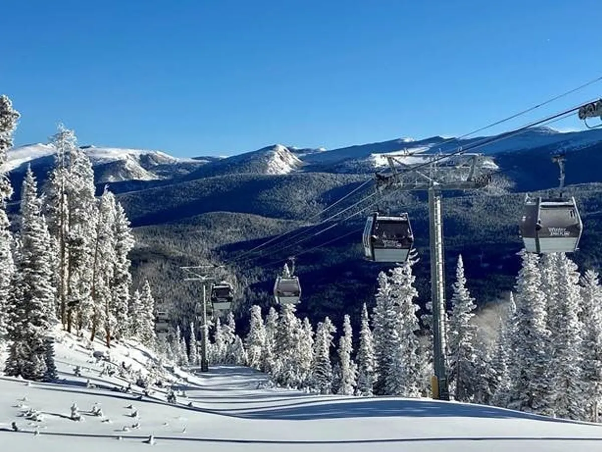 An exterior, scenic image of snow-covered mountains, pine trees, and ski lifts, evoking the beauty and thrill of a winter playground. The scene suggests active pursuits like skiing and snowboarding against a dramatic alpine background.